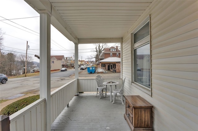 view of patio / terrace featuring a porch and a residential view