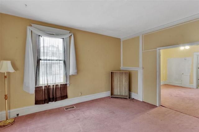 unfurnished room featuring carpet, visible vents, and baseboards