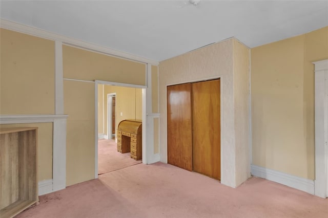 unfurnished bedroom featuring carpet and a closet