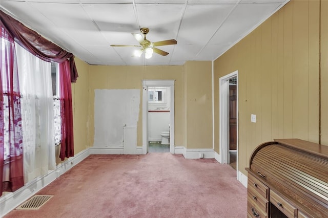 bedroom featuring light colored carpet, visible vents, connected bathroom, ceiling fan, and baseboards