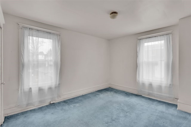 carpeted spare room with a wealth of natural light