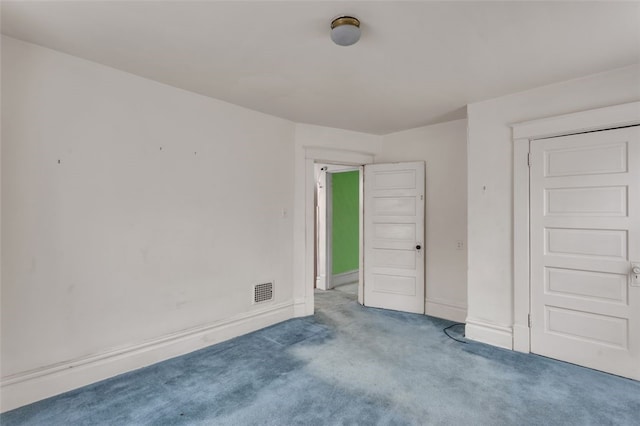 unfurnished bedroom with carpet floors, visible vents, and baseboards