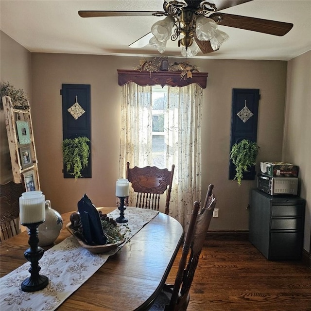 dining room featuring ceiling fan, baseboards, and wood finished floors