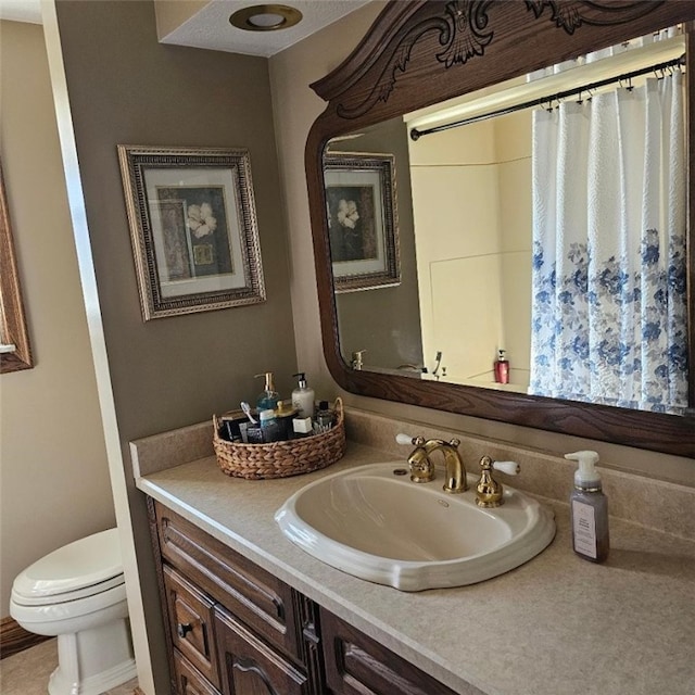 bathroom featuring toilet and vanity