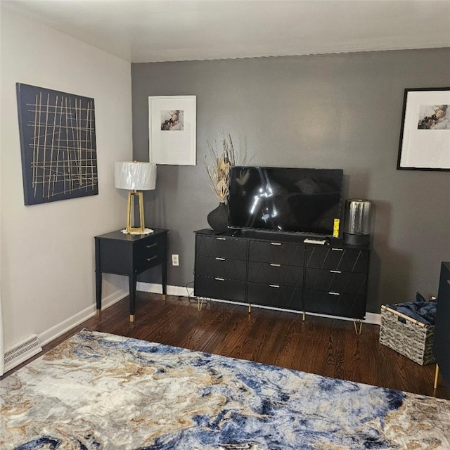 living area with dark wood finished floors and baseboards