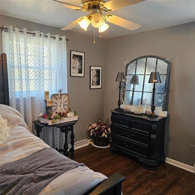 bedroom featuring ceiling fan, baseboards, and wood finished floors