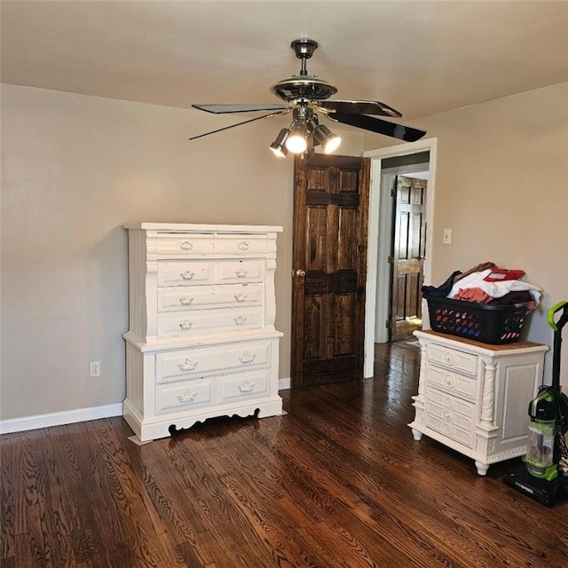 unfurnished bedroom featuring dark wood-style floors, a ceiling fan, and baseboards