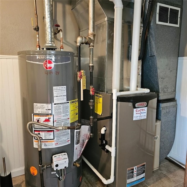 utilities with visible vents and gas water heater