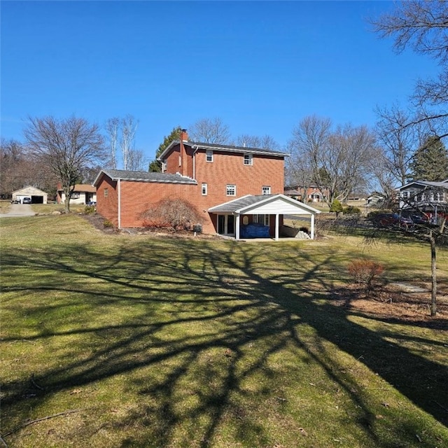 back of house with a lawn and a chimney