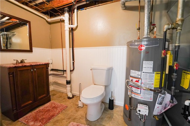 127 Stickle Rd, Chippewa Twp, PA 15010 - bathroom with water heater, a wainscoted wall, vanity, toilet, and tile patterned flooring