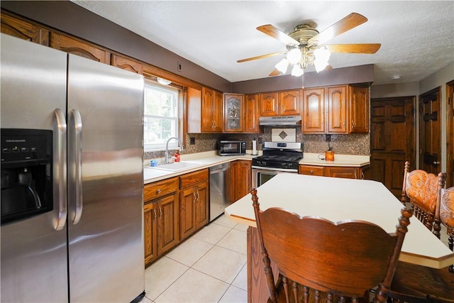 127 Stickle Rd, Chippewa Twp, PA 15010 - kitchen with appliances with stainless steel finishes, a sink, under cabinet range hood, and brown cabinets