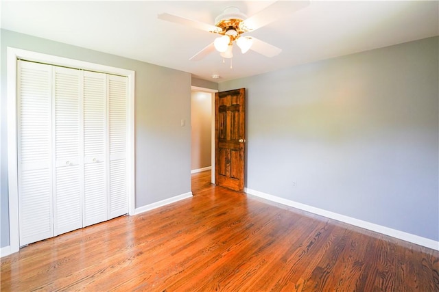 127 Stickle Rd, Chippewa Twp, PA 15010 - unfurnished bedroom with baseboards, a closet, wood finished floors, and a ceiling fan