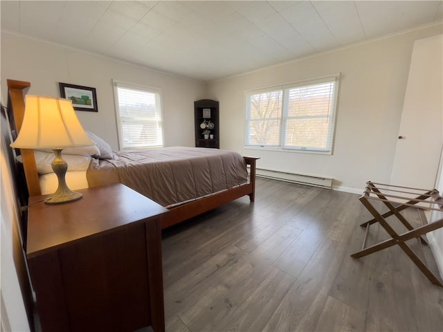 bedroom with baseboards, ornamental molding, baseboard heating, and wood finished floors