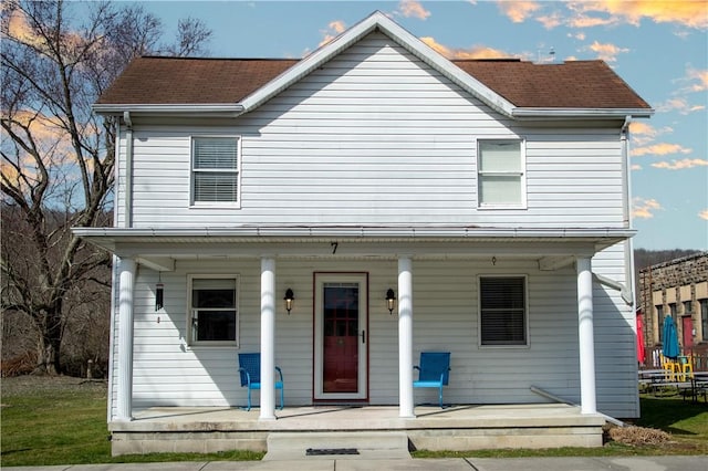 view of front of home with covered porch and roof with shingles