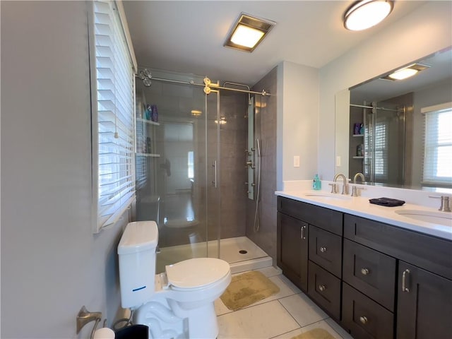 bathroom with a sink, tile patterned floors, and a shower stall
