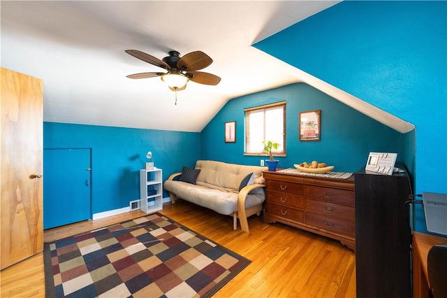 sitting room featuring a ceiling fan, lofted ceiling, visible vents, and wood finished floors