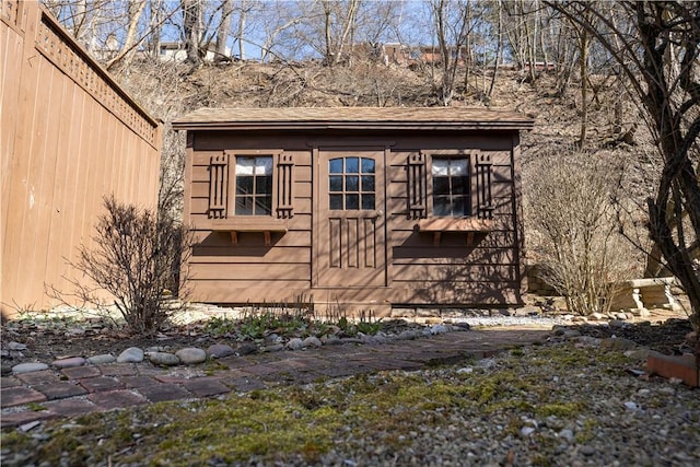 view of property exterior featuring an outbuilding and a storage unit