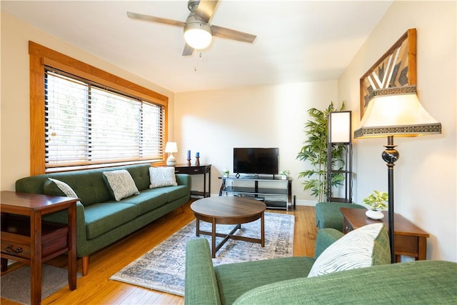 living room with a ceiling fan and wood finished floors