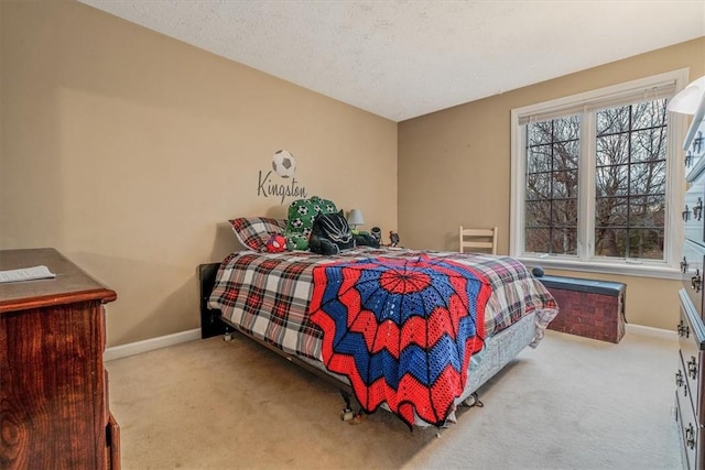 bedroom featuring a textured ceiling, baseboards, and carpet flooring