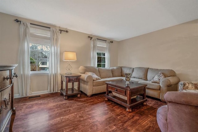 living room with dark wood finished floors and visible vents