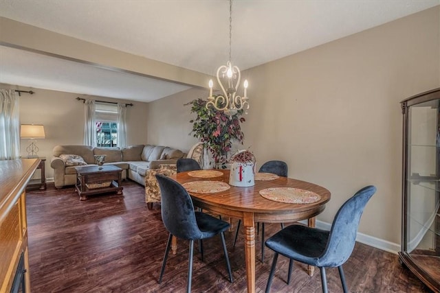 dining space with a chandelier, baseboards, and wood finished floors