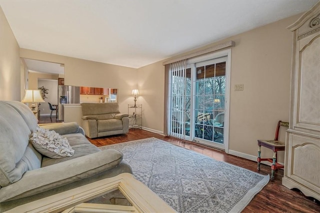 living room featuring baseboards and wood finished floors