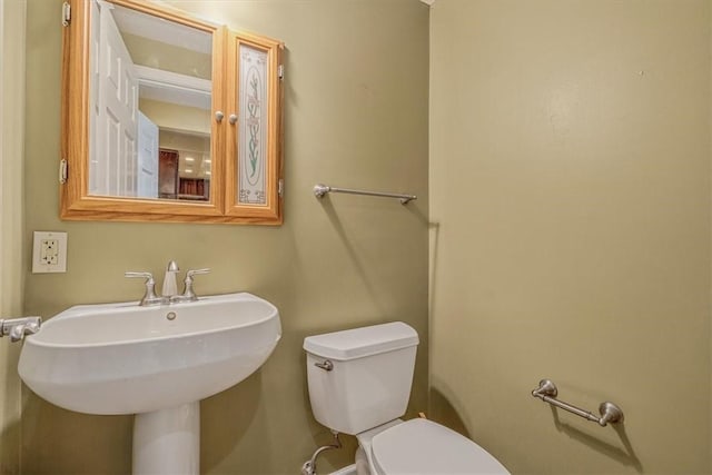 half bathroom featuring a sink and toilet