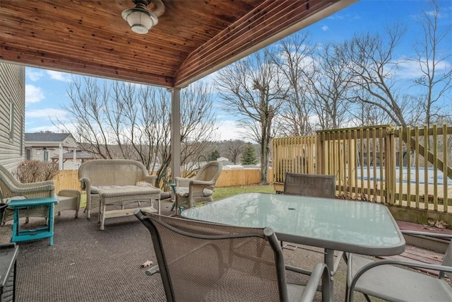 view of patio featuring ceiling fan, outdoor dining space, and an outdoor living space