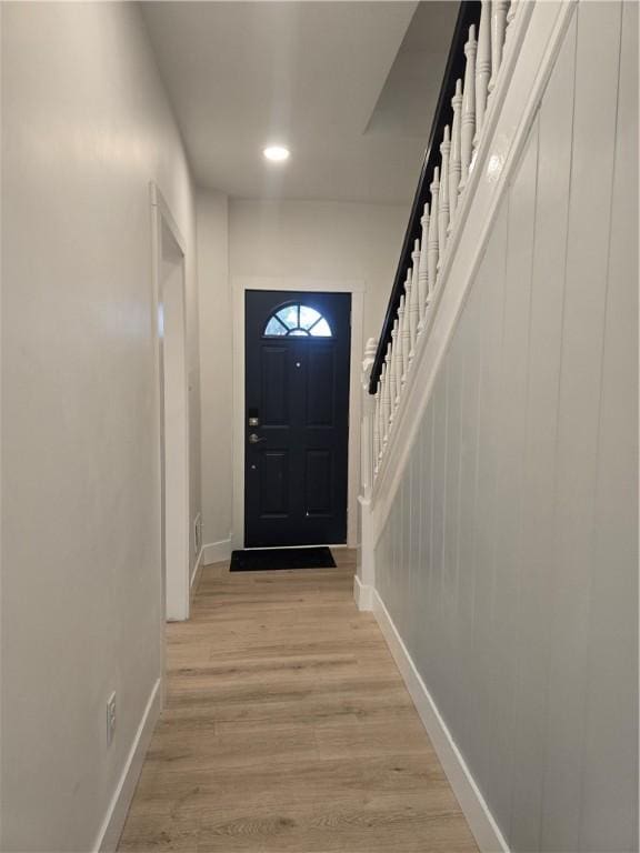 doorway to outside with stairway, recessed lighting, light wood-style flooring, and baseboards