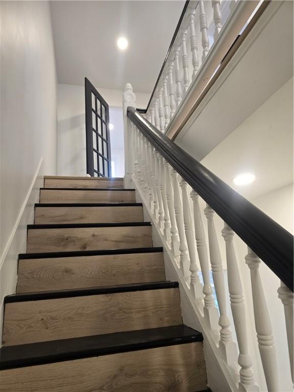 staircase featuring recessed lighting