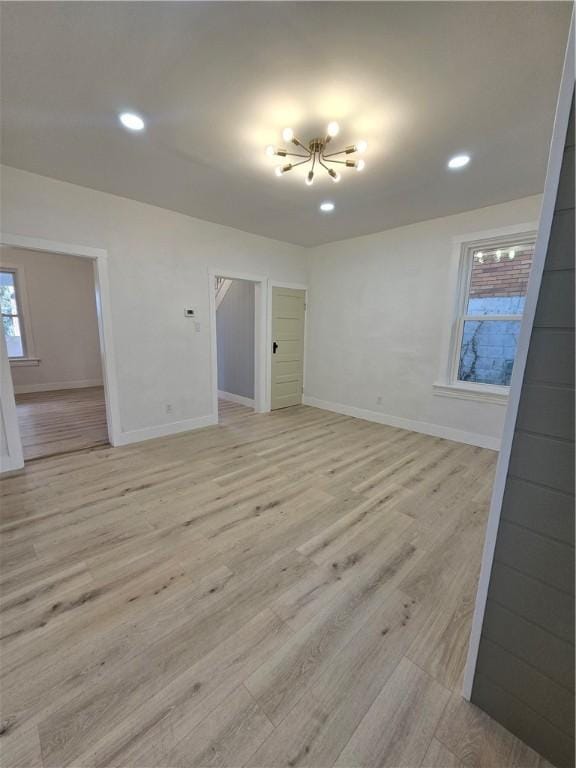 unfurnished room featuring recessed lighting, baseboards, and light wood finished floors