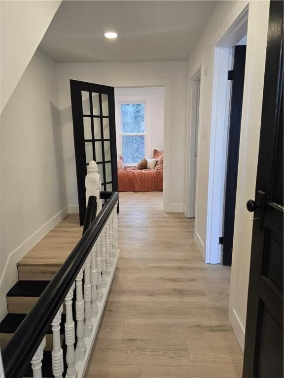 hallway featuring stairway, recessed lighting, light wood-style flooring, and baseboards