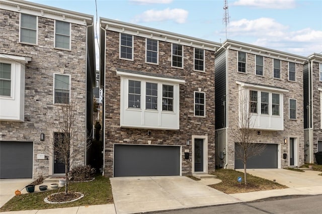 townhome / multi-family property with an attached garage and concrete driveway