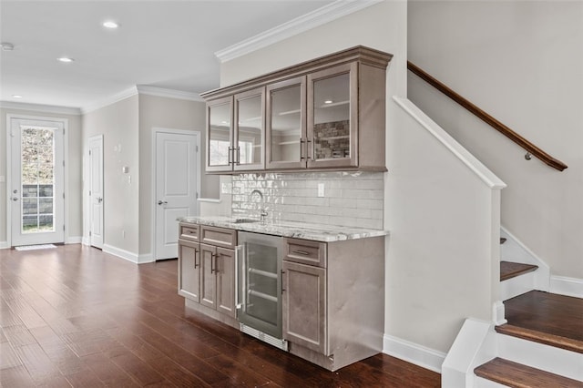 bar featuring dark wood-style floors, wine cooler, stairway, and crown molding