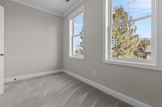 unfurnished room featuring carpet flooring, crown molding, visible vents, and baseboards