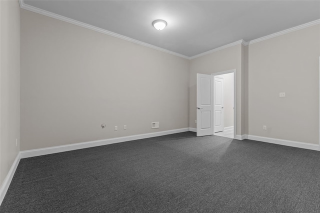 empty room featuring ornamental molding, dark colored carpet, and baseboards