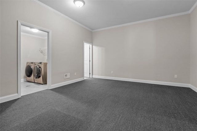 carpeted empty room with baseboards, ornamental molding, and separate washer and dryer