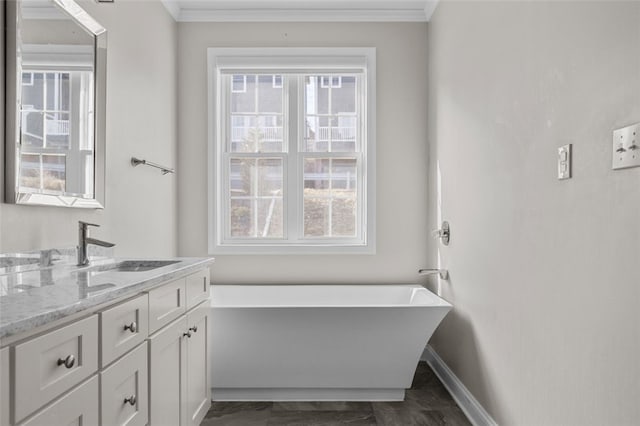 full bathroom with crown molding, a freestanding bath, vanity, and a healthy amount of sunlight