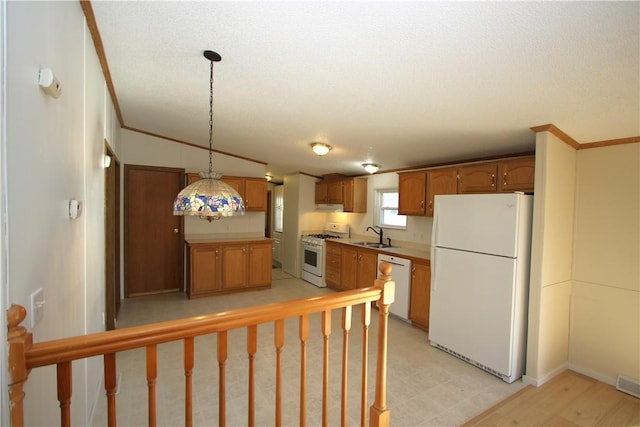 kitchen with decorative light fixtures, crown molding, light floors, a sink, and white appliances