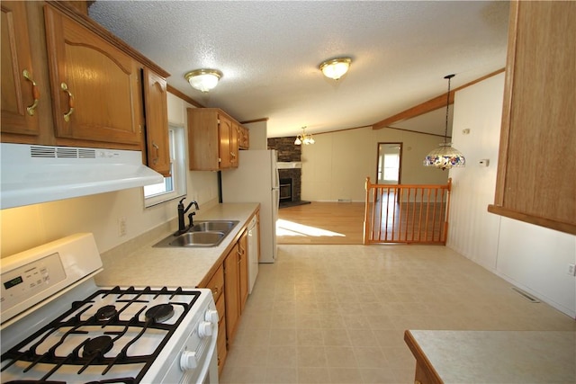 kitchen featuring white appliances, lofted ceiling with beams, range hood, light countertops, and a sink