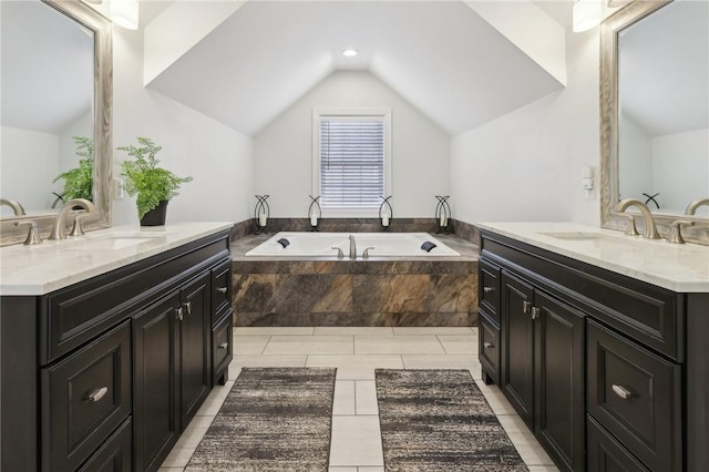 full bathroom with vaulted ceiling, two vanities, and a sink