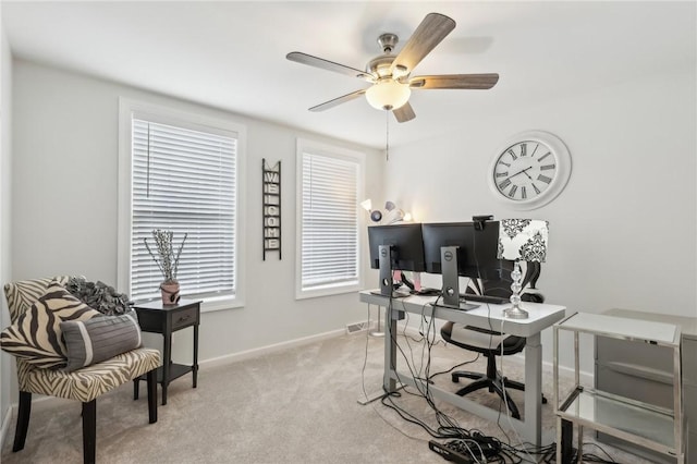 office with visible vents, baseboards, a ceiling fan, and light colored carpet