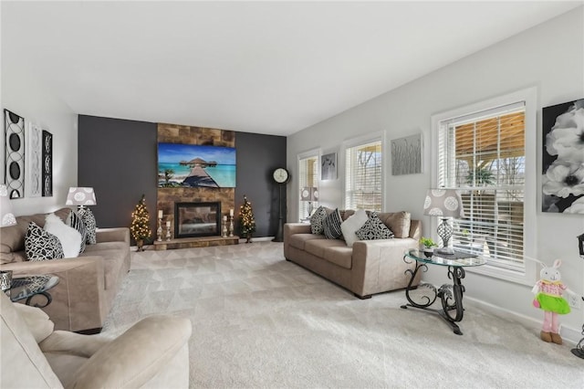 living area with a fireplace, baseboards, and light colored carpet