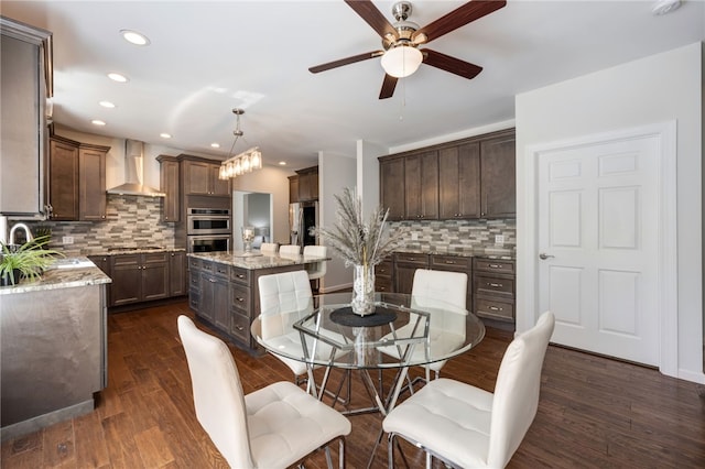 dining room featuring dark wood finished floors, a ceiling fan, and recessed lighting