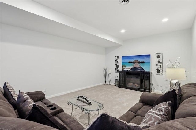 living room featuring recessed lighting, carpet floors, visible vents, baseboards, and a glass covered fireplace