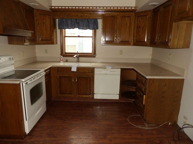 kitchen featuring white appliances, light countertops, a sink, and custom exhaust hood