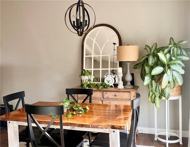 dining area with a notable chandelier, wood finished floors, and baseboards