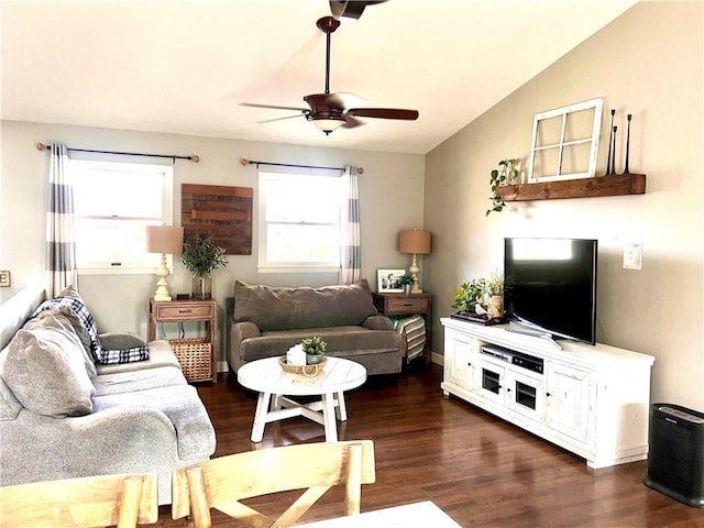 living room with lofted ceiling, ceiling fan, and dark wood-type flooring