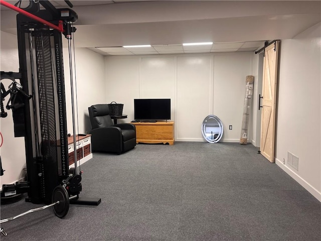 exercise area with baseboards, visible vents, and a drop ceiling