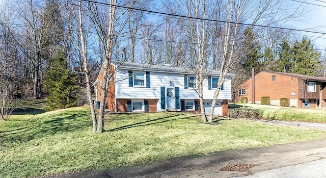 raised ranch with brick siding and a front lawn